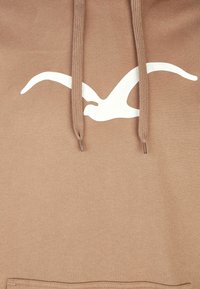 Felpa marrone con logo di un uccello bianco. Presenta cordini piatti e una texture morbida. Design semplice e casual, senza motivi né accenti.
