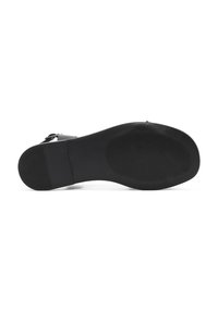 Suola di scarpa nera con una superficie liscia, caratterizzata da un motivo di presa testurizzato e un tacco arrotondato. Materiale resistente e design minimalista.