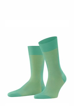 Light green socks made from a smooth, stretchy material. Features ribbed tops, seamless toes, and a subtle lighter green stripe pattern.