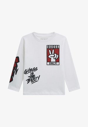 Tricou alb cu mâneci lungi, cu imprimeuri grafice în roșu și negru, având cutia "GUESS ONLY" și textul "GUESS is THE BEST!". Material moale.