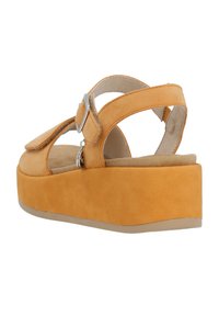 Yellow suede platform sandals with a wide strap, open back, and adjustable buckle closure. Soft, textured upper and cushioned footbed.