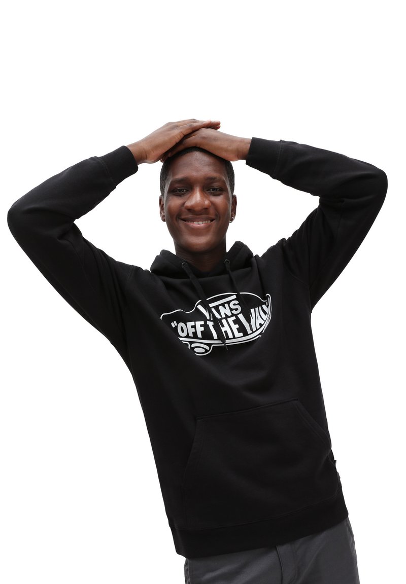 Sudadera negra con un bolsillo frontal, presenta un logo gráfico blanco. El material parece suave, con capucha ajustable y puños de canalé.