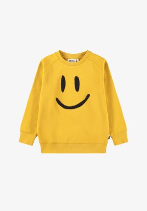 Sweat-shirt jaune à manches longues avec un dessin de visage souriant noir sur le devant et un col rond, étiqueté "Molo" à l'intérieur du col.