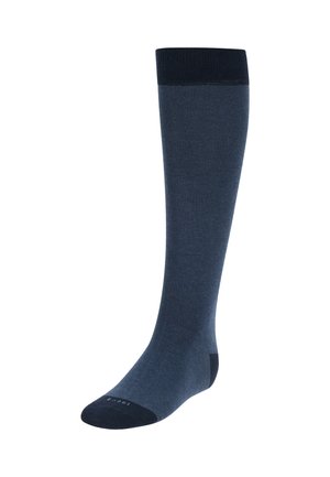 Chaussettes montantes de couleur bleu marine foncé, fabriquées en tissu lisse avec une bande supérieure côtelée et des accents contrastants aux orteils et au talon de couleur foncée.