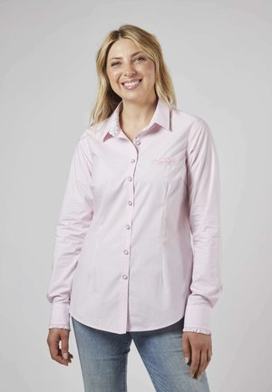 Chemise rose clair à manches longues avec un col à motif floral et des accents aux poignets. Présente une fermeture à boutons et un subtil détail brodé sur la poitrine.