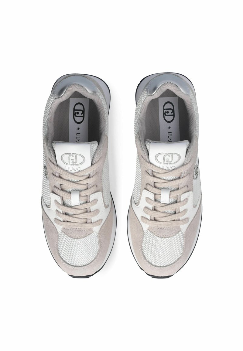 Baskets gris clair et blanches avec des textures en maille et en daim, dotées de lacets ronds, d'un col rembourré et d'un logo sur la languette.
