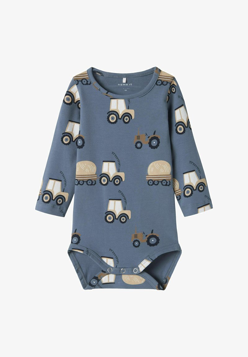 Long-sleeve baby bodysuit in blue with tractor and hay patterns. Made from soft fabric with snap closures at the bottom for easy dressing.