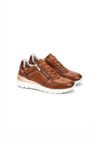 Zapatillas de cuero marrón con suelas blancas, con cordones en la parte delantera y cremalleras funcionales a los lados, mostradas en un par lado a lado.