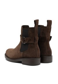 Brown suede ankle boots with elastic side panels, a buckle accent, and a chunky rubber sole, featuring a smooth texture and rounded toe.