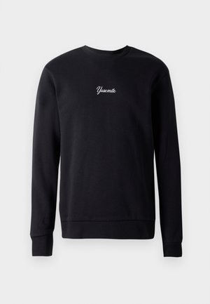 Svart sweatshirt av bomullsblandning med rund hals och långa ärmar. Har vit kursiv brodyr som säger "Yosemite" på bröstet.