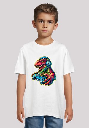 White t-shirt featuring a colorful graphic of a dinosaur wearing headphones and holding a game controller, with detailed line work and vibrant colors.