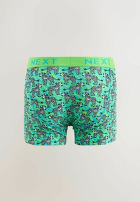 Zöld boxer nadrág fekete-fehér zebra mintázattal, élénk zöld rugalmas derékkal, amelyen a "NEXT" felirat olvasható. Puha, rugalmas anyag.