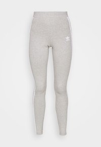 Grå leggings i ett mjukt material, med vita sidosträck och en liten vit logga på framsidan. Åtsittande design med hög midja.