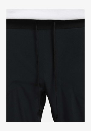 Sorte atletiske shorts med en glat tekstur, der har en sort taljeelastik og justerbare snore. Sidelommer er synlige.