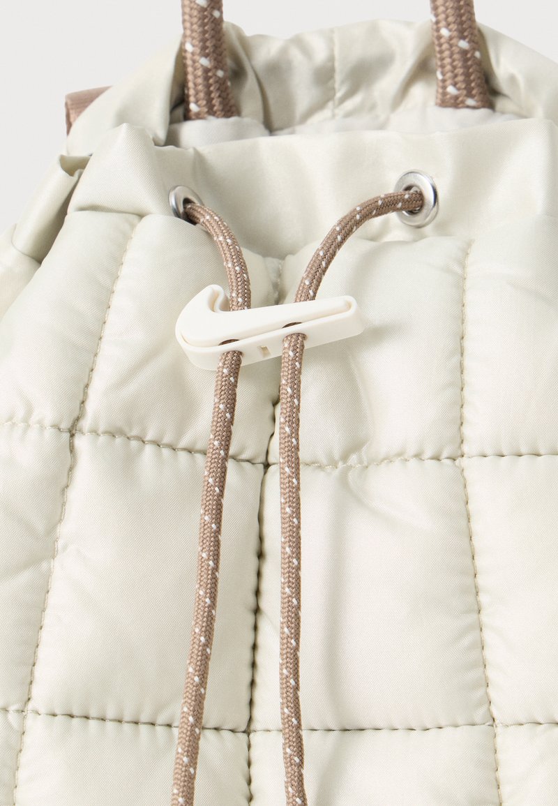 nike backpack nude Sportswear Palentino Women's Beige An old favorite reimagined Nike Medium Convertible Diaper Bag