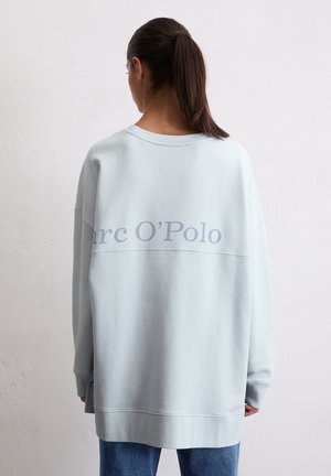 Jasnoniebieski, oversize'owy sweter z miękkiej tkaniny, z okrągłym dekoltem i logo "Marc O’Polo" na plecach, z prążkowanymi mankietami.