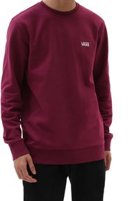 Felpa color bordeaux realizzata in misto cotone, con scollatura a girocollo e polsini a costine. Logo "VANS" in bianco sul lato sinistro del petto.