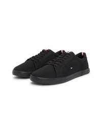 Black canvas sneakers with a rounded toe, flat lace-up design, and rubber sole. Features a small logo and red, white, and blue accents.