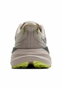Trail running shoe in beige with a textured mesh upper, grey accents, and a green rubber sole. Features a padded heel for comfort.