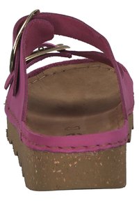 Pink sandal with a cork sole and a strap design. Features a gold-tone buckle and suede accents. Flat and open-back style for ease.