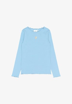 Top lung cu mâneci lungi, de culoare albastră deschisă, cu textură în relief, având un decolteu cu margini ondulate și un detaliu mic în formă de inimă pe piept. Corsetul este ușor scurtat.