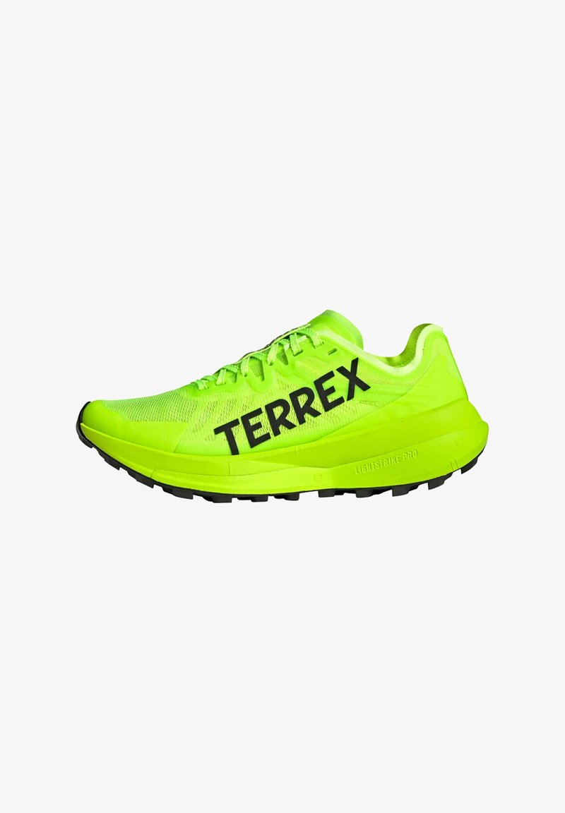 Neon green athletic shoe with black "TERREX" logo, breathable mesh upper, textured sole, and lightweight design.