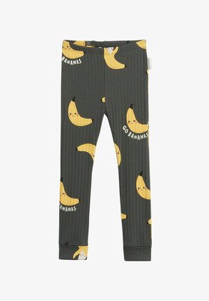 Donkergrijze geribbelde kindertights met glimlachende banaanillustraties en de tekst "Go Bananas" verspreid over de stof.