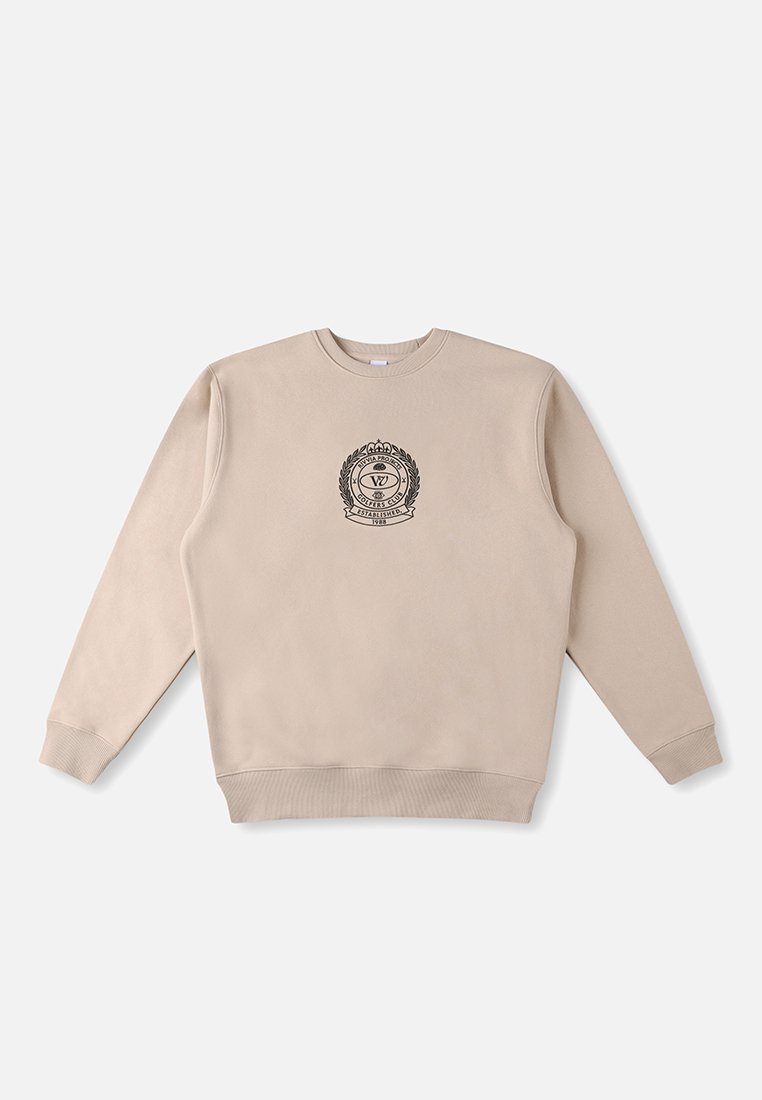 Bež dukserica s dugim rukavima, rebrastim ovratnikom i rubom, s centralno smještenim crnim amblemom s lovorovim detaljima. Glatka pamučna tekstura.