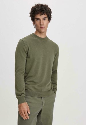 Green knit pullover with a round neckline and ribbed cuffs and hem. Textured fabric, fitted design, paired with matching pants.