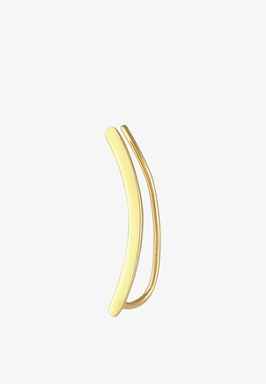 Épingle à cheveux dorée avec deux pointes courbées. Le design présente des surfaces lisses et brillantes ainsi qu'une forme épurée et minimaliste.