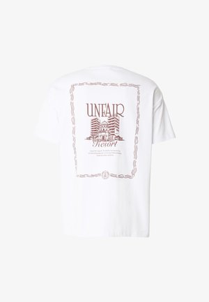Hvit T-skjorte med brunt trykk av bygninger innrammet av en bølget linjeborder og tekst som sier «UNFAIR Resort» på baksiden.