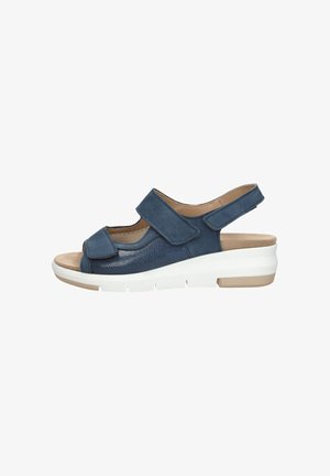 Navy blue sandal with two velcro straps, peep toe, textured material on the body, white lightweight sole with a subtle tan accent.