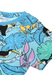 Short-sleeve shirt featuring a blue background with tropical leaf and toucan patterns, made of soft fabric with a crew neckline.
