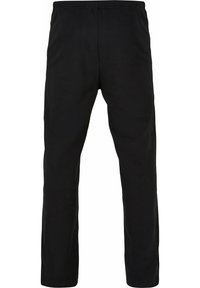 Pantaloni negri până la gleznă, confecționați dintr-un material moale, cu talie elastică și tăieturi laterale la tiv pentru libertate de mișcare.