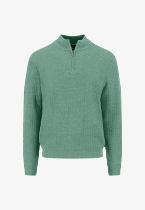 Vaaleanvihreä, teksturoidulla pinnalla varustettu villapaita, jossa on puolivetoketjullinen kaulus ja pitkät hihat. Resorireunus helmassa ja hihansuissa, jossa on kudottu kuvio kauttaaltaan.