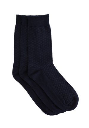 Trois paires de chaussettes bleu marine foncé avec un motif texturé à carreaux, des côtes aux poignets et des semelles lisses pour le confort.