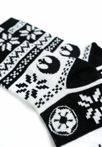 Calzini a righe bianche e nere con motivi di fiocchi di neve, simboli dell'Alleanza Ribelle e un emblema Imperiale. Realizzati in morbido materiale lavorato a maglia.