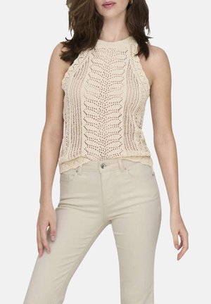 Haut halter en tricot crème avec un motif texturé et un ourlet festonné. Assorti à un pantalon fitted beige clair.