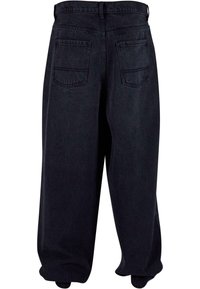 Dark denim trousers with a loose fit, featuring a high waist, two back pockets, and finished hem. The fabric has a smooth texture.