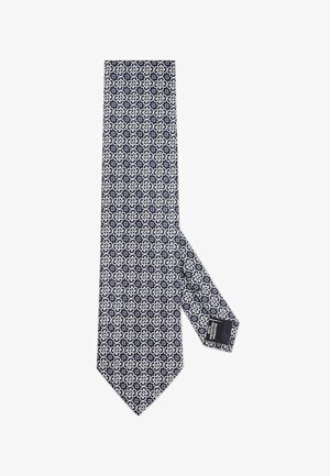 Granatowy krawat z białym geometrycznym wzorem. Gładki jedwabny materiał z ostrym końcem i metką na spodniej stronie.