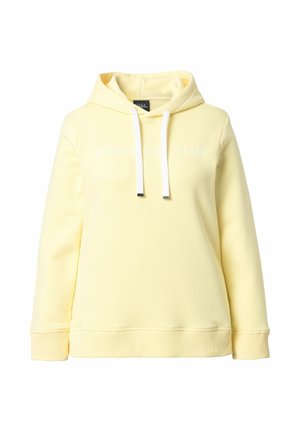 Vaaleankeltainen hupullinen collegepaita valkoisilla kiristysnauhoilla ja hillityllä valkoisella tekstillä rinnan kohdalla, pitkät hihat sekä resorit hihoissa ja helmassa.