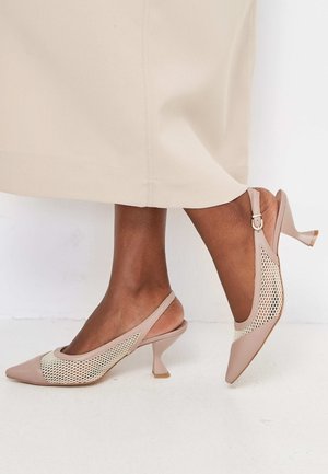 Pointed-toe slingback shoes in light pink with a mesh panel design. Features a low stiletto heel and adjustable buckle strap. Smooth texture.