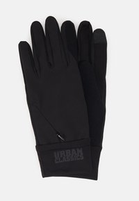 Mănuși negre cu un design elegant, dotate cu un buzunar cu fermoar, vârf texturat pentru utilizarea pe ecrane tactile și un finisaj din țesătură moale.