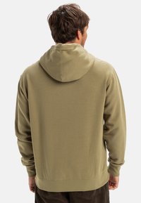 Olive green hooded sweatshirt made of soft fabric, featuring a relaxed fit, long sleeves, and a kangaroo pocket at the front.