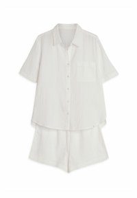 White short-sleeve shirt with button closure and pocket, paired with matching shorts. Made of lightweight, textured fabric.