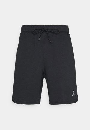 Shorts de sport noirs avec une ceinture élastique et un cordon de serrage, ornés d'un petit logo blanc Jumpman sur la partie inférieure de la jambe gauche.