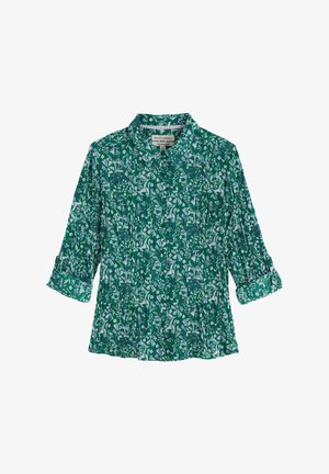 Blouse verte à motifs floraux avec un col, une texture plissée et des manches trois-quarts. Présente des motifs de fleurs blanches et violettes sur l'ensemble.