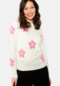 White sweater with pink floral patterns, round neck, long sleeves, and ribbed hem. Soft fabric, fitted design, and casual style.