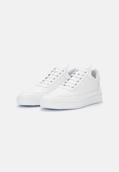 White leather sneakers with a low-top design, rounded toe, and flat laces. Features metallic eyelets and a textured sole for grip.