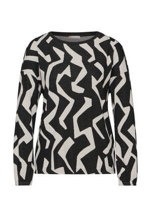 Haut à manches longues noir et blanc avec un motif zigzag abstrait, encolure ras du cou et tissu texturé. Poignets extensibles aux manches.